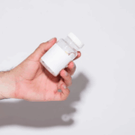 a hand holding a supplement bottle